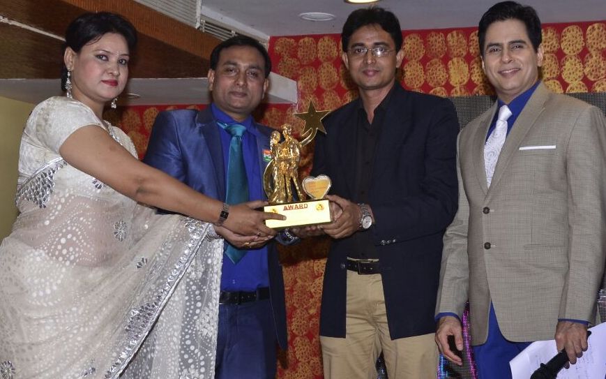 Yogesh Mishra (2nd from right) while recieving award